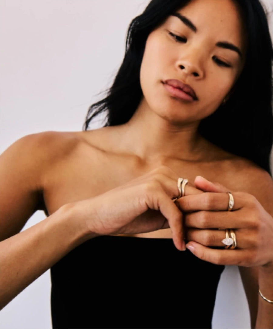 Woman in a black top wearing stacked Kayge rings
